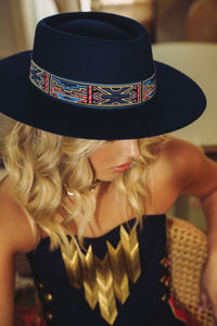 modern boater style hat in navy colour with aztec style ribbon in navy, red, purple and gold