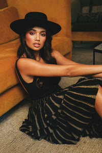 black boater hat with black and gold outfit
