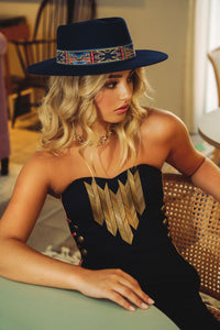 modern boater style hat in navy colour with aztec style ribbon